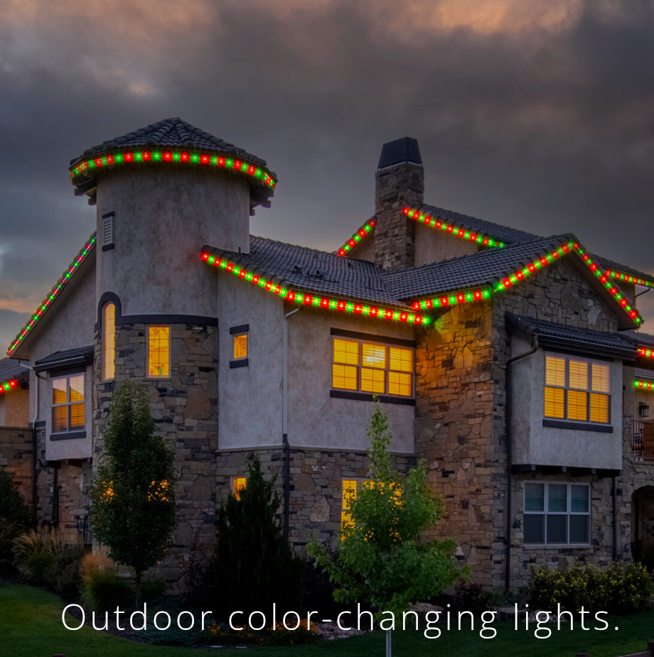 House roofline outlined with red and green holiday lights