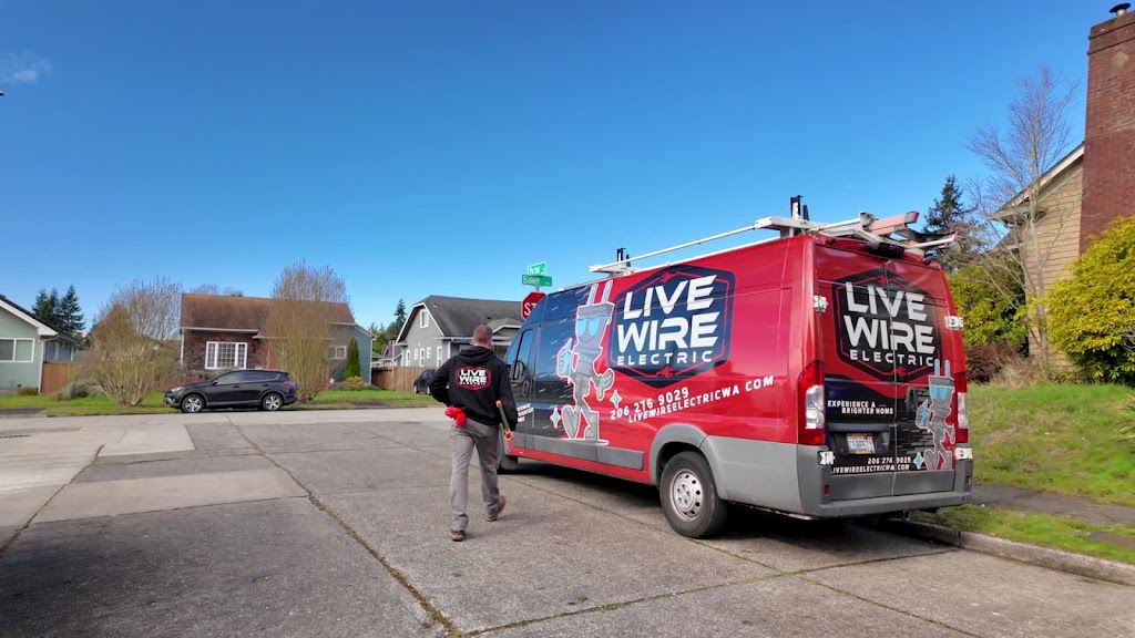 A Live Wire Electric technician walking beside a service van on a residential street
